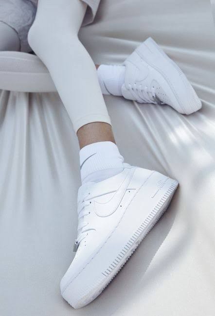 Stylish all-white Nike Air Force 1 sneakers for men & women.