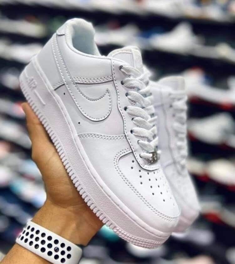 Lifestyle shot of Nike Air Force 1 Triple White sneakers in Pakistan.