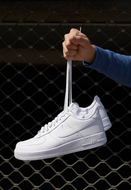 Lifestyle shot of Nike Air Force 1 Triple White sneakers in Pakistan.