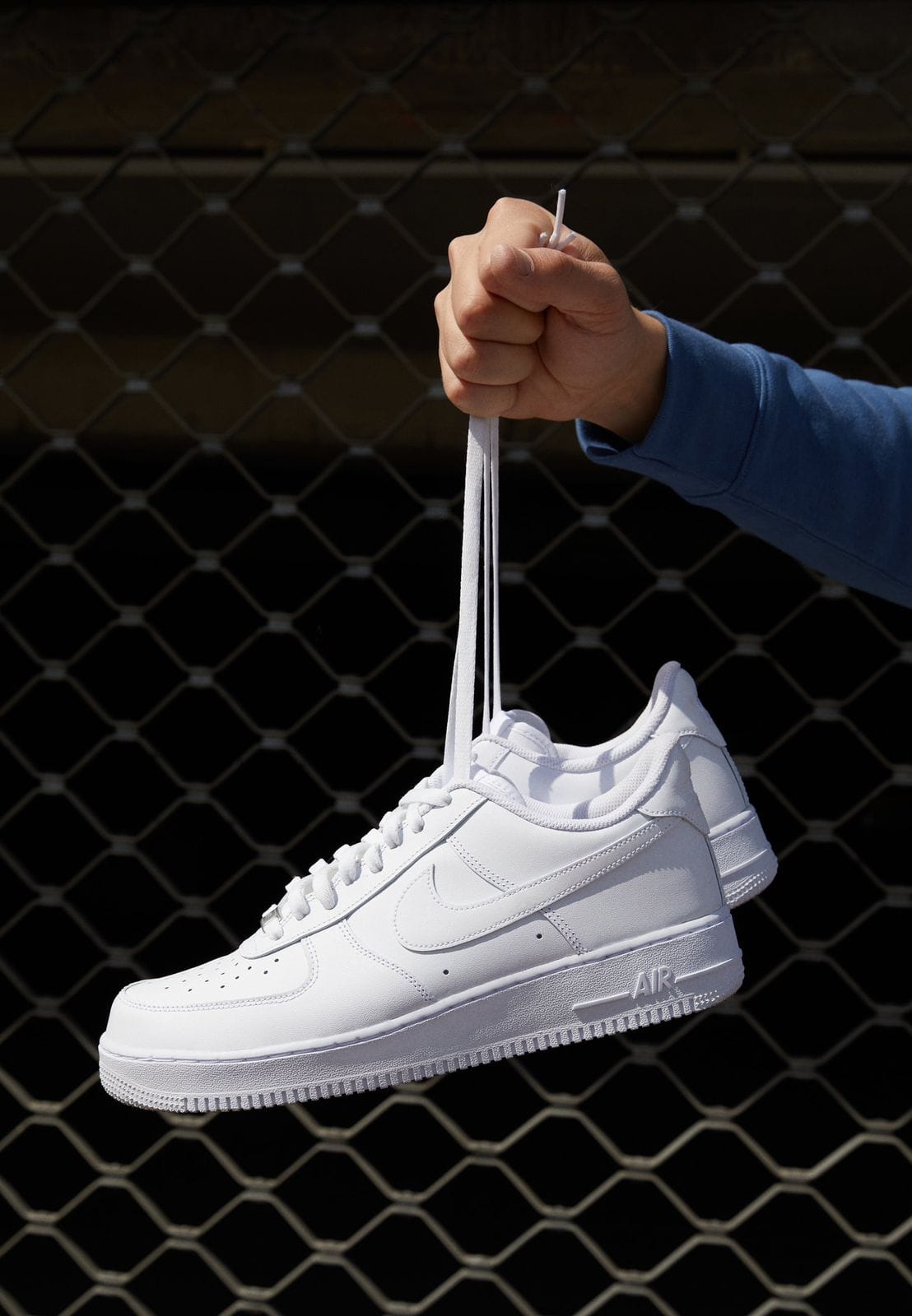 Lifestyle shot of Nike Air Force 1 Triple White sneakers in Pakistan.