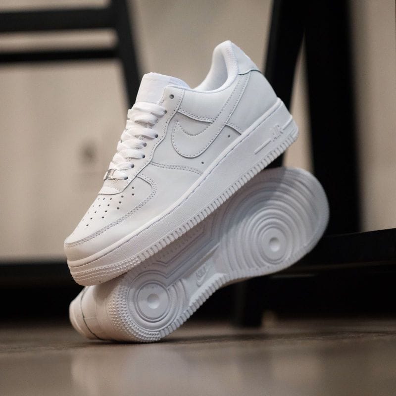 Stylish all-white Nike Air Force 1 sneakers for men & women.